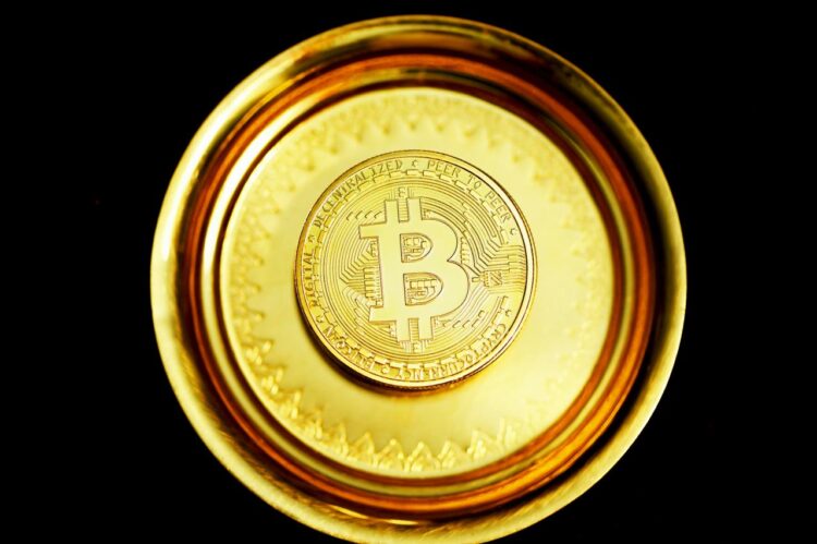 gold round coin on black surface